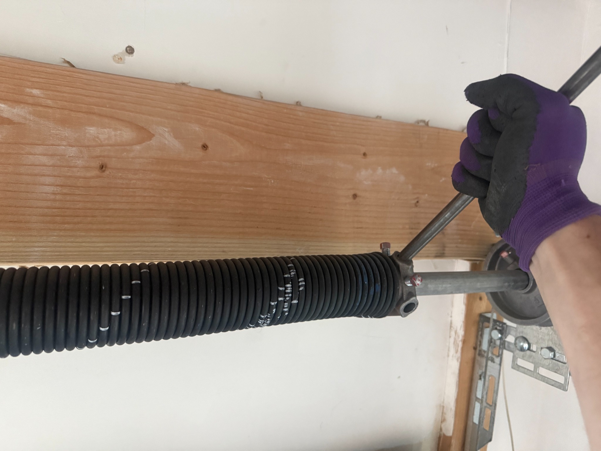 Garage door torsion spring being serviced