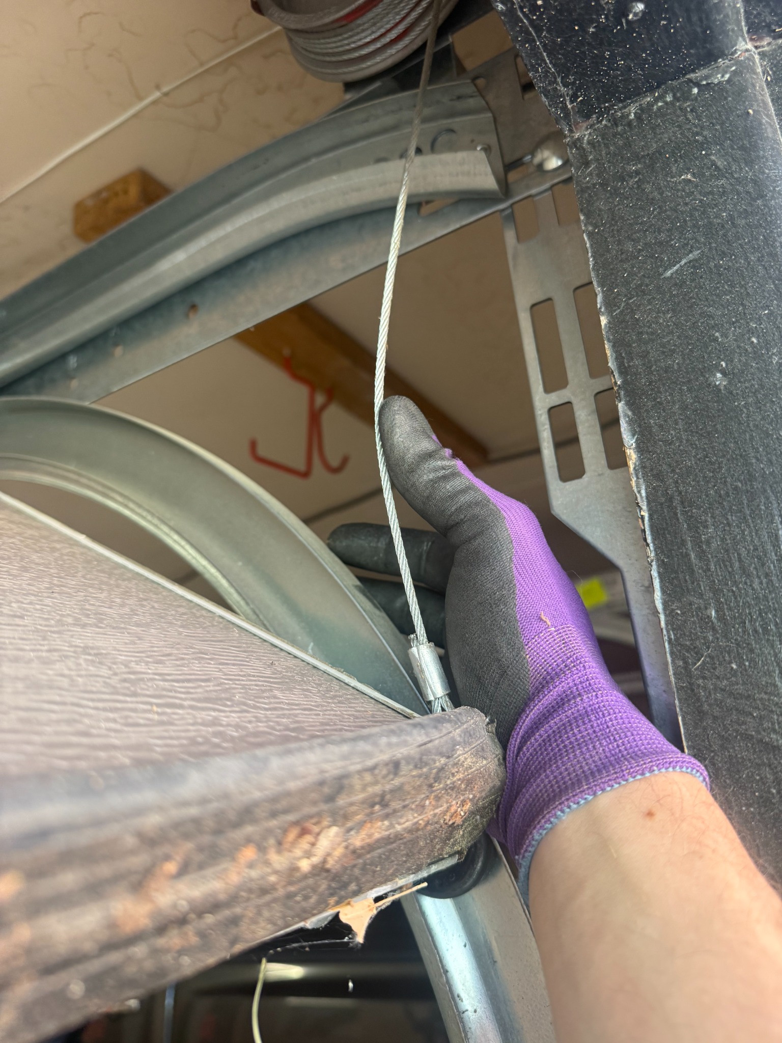 Close view of garage door hardware during an inspection