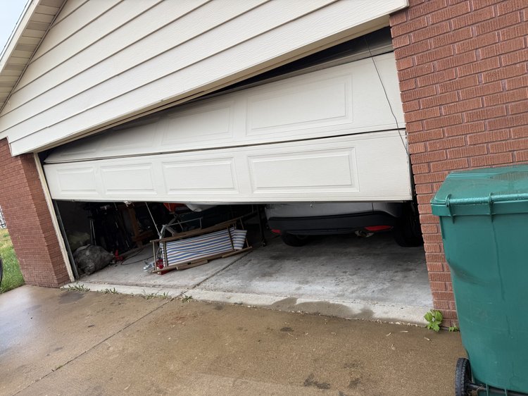 Garage door before off-track repair in Layton